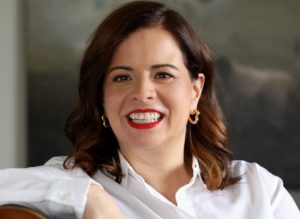 Imagem de Lina com pele clara, batom vermelho e blusa branca